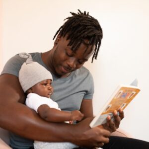 Man in Grey Shirt holding his infant child wanting to choose a Child Arrangement Lawyer