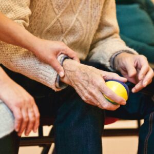 A woman being chosen as a Power of Attorney for her father who is holding a stress ball