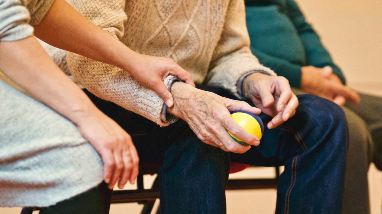 Choosing the Best Power of Attorney for You: 5 Crucial Questions To Ask 1 A woman being chosen as a Power of Attorney for her father who is holding a stress ball
