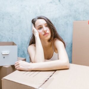 Woman Surrounded by Boxes Representing The Abolishment Of Section 21