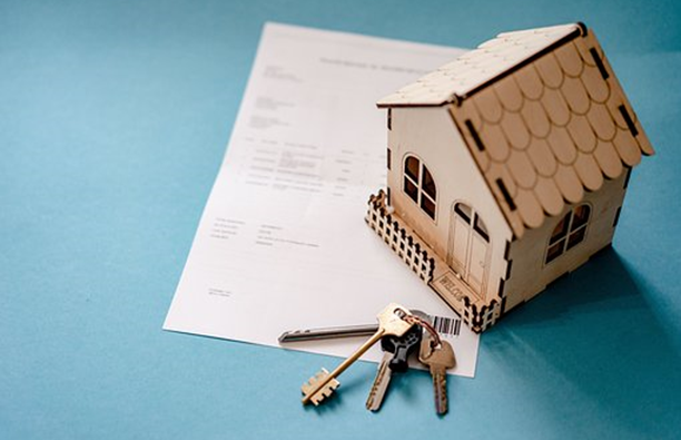 Transfer of Equity: Is It Possible To Add A Name To My Property? 1 Small wooden toy house and set of house keys sitting on top of paperwork for a property to show if its possible to add a name to my property, transfer of equity