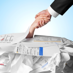A person buried in debt papers holding up a hand with a person in a suit holding the buried person’s hand helping them out to show the reality of knowing about recovering debt, dispute resolution in court, business dispute, civil dispute advice